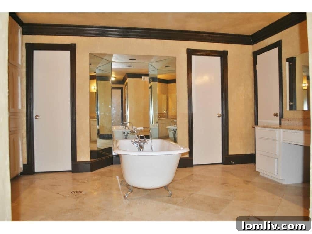 Luxurious master bathroom with a large, freestanding footed soaking tub and ample space.