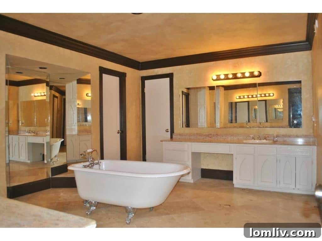 Spacious master bath with dual vanity sinks, extensive counter space, and modern fixtures.