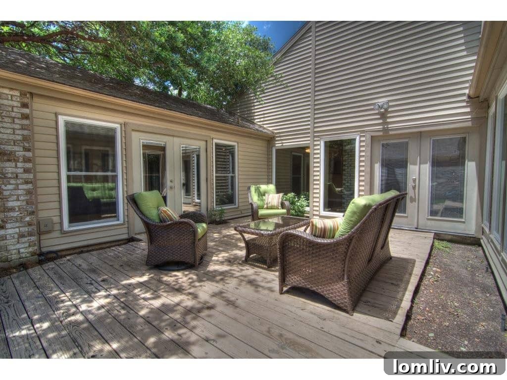 Another view of the spacious wooden deck and backyard at 18605 Crownover Court, Dallas.