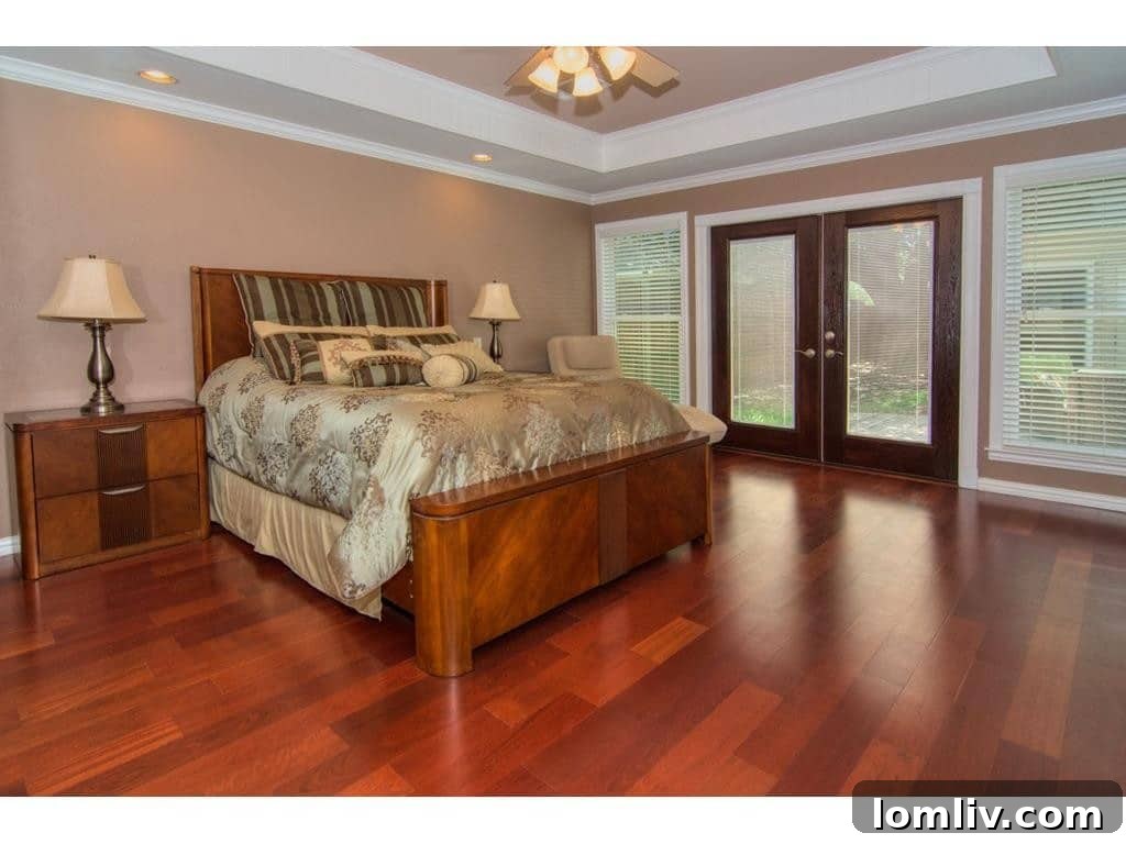 Spacious master bedroom with new floors and a tray ceiling at 18605 Crownover Court.