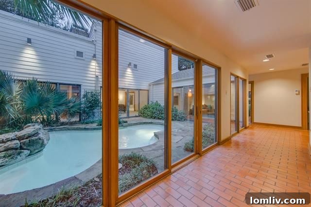 Expansive living area with abundant natural light overlooking the pool