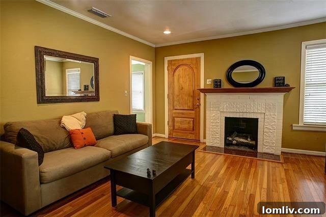 Charming living room with original fireplace and hardwood floors