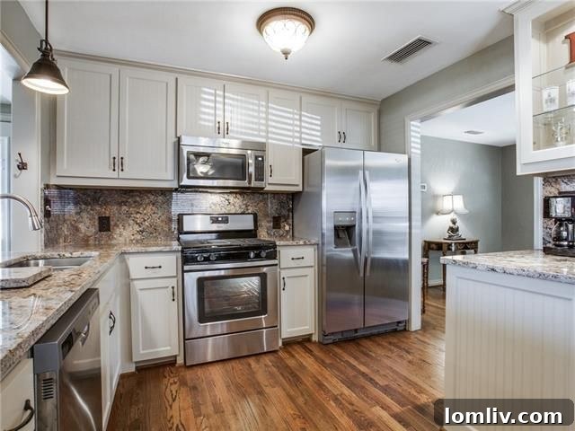 Modern kitchen with white cabinets, granite, and stainless steel appliances