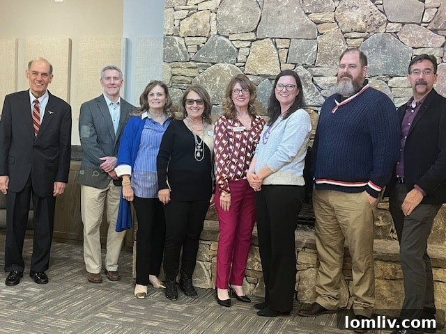 Pictured are Fernando Costa, James Anderson, Linda McMahon, Kay Carroll, Donna VanNess, Sarah Geer, Thor Erickson, and Matt Hull.