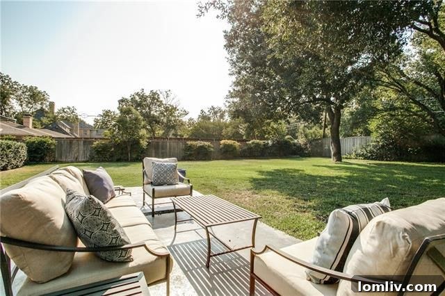 Lush backyard with mature trees, landscaping, and plenty of green space