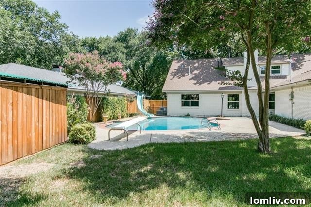 Expansive diving pool with a slide, perfect for summer entertainment