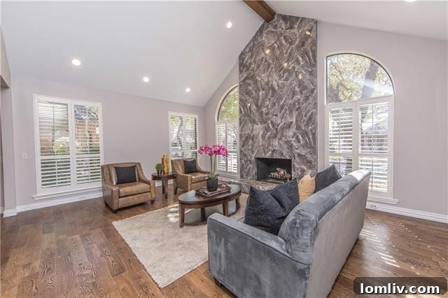 Dramatic living room with stone fireplace and large windows