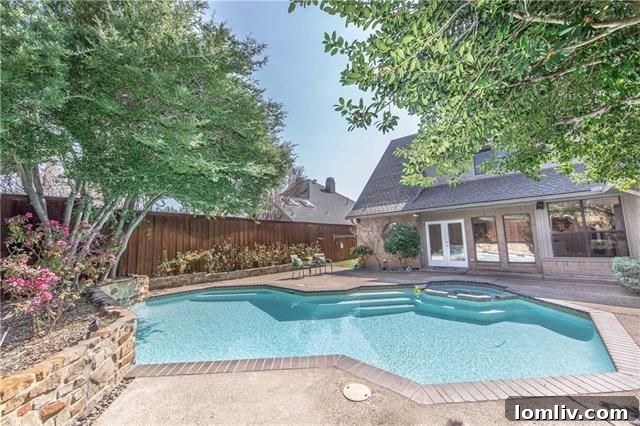 Resort-style swimming pool in landscaped backyard