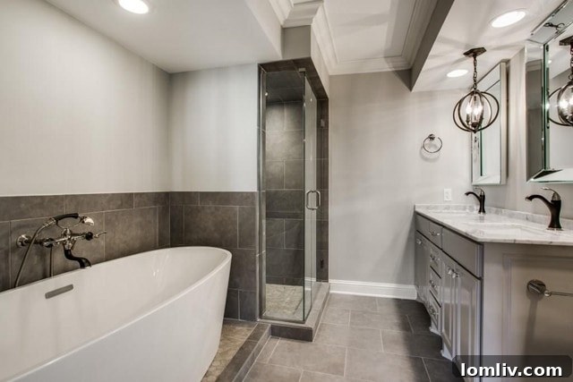 Luxurious renovated master bathroom with double vanity, glass shower, and freestanding tub in a modern Dallas condo