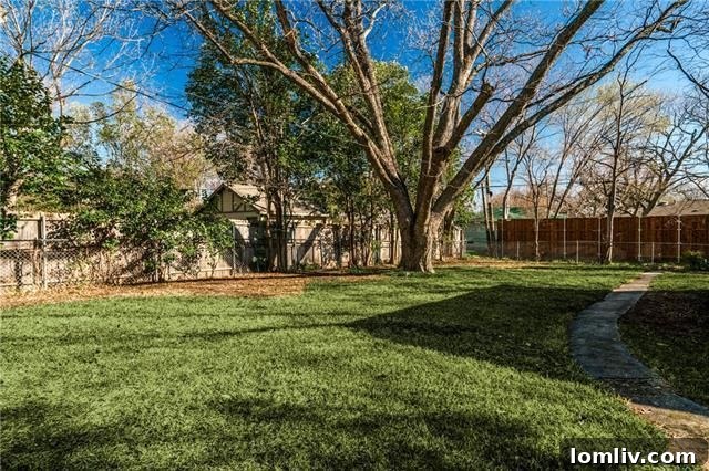 Spacious Backyard with Deck and Mature Trees in Dallas Home