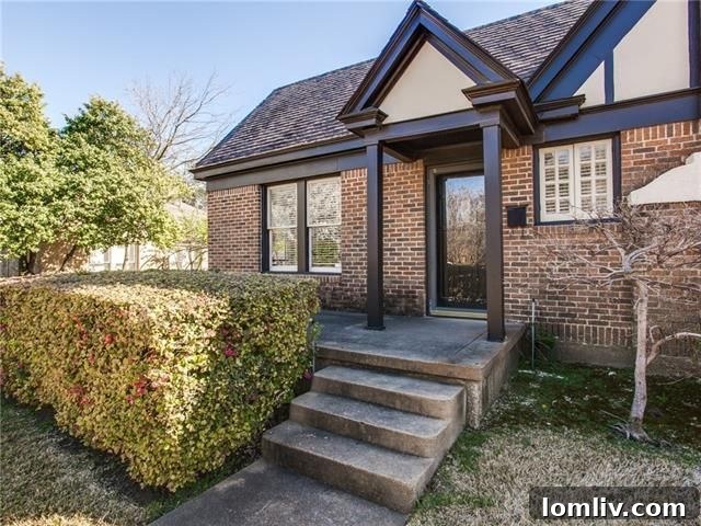 Found: Your North Oak Cliff Tudor Dream Home 3 Lounge area with custom glass-front cabinets and brick fireplace in Tudor home at 834 Salmon Drive