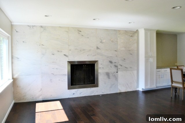 Midway Hollow: Nathan Draper's Passion Project 4 Remodeled living room at 4069 Park Lane by Draper Construction featuring an original marble wall and high-end finishes