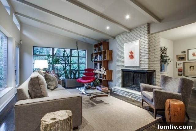 Light-filled living room featuring a dimensional retro fireplace and vaulted ceilings.