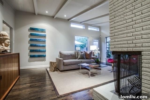Modern upscale kitchen with white cabinets, stainless steel appliances, and a farm sink.