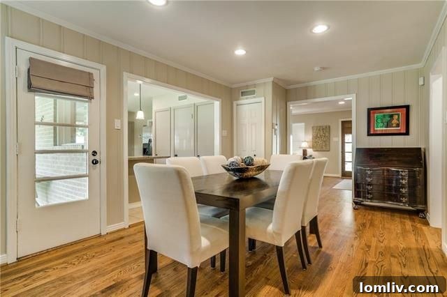 The elegant kitchen with granite tile counters, cream-colored cabinets, and stainless steel appliances.