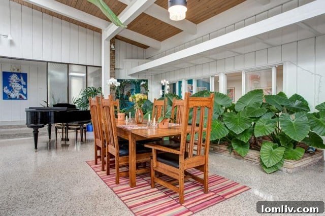 Open plan living area with dining table and piano
