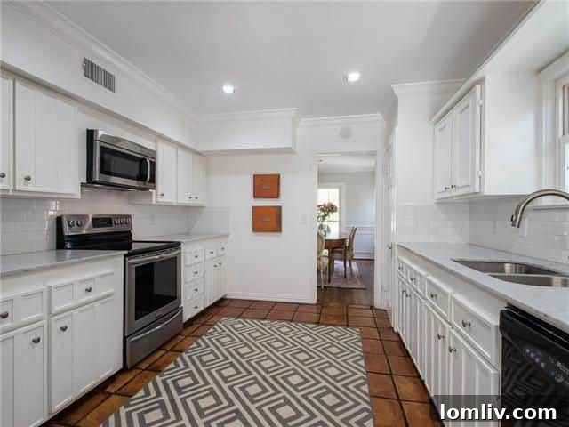 Renovated modern kitchen with subway tile, white cabinets, and stainless steel appliances