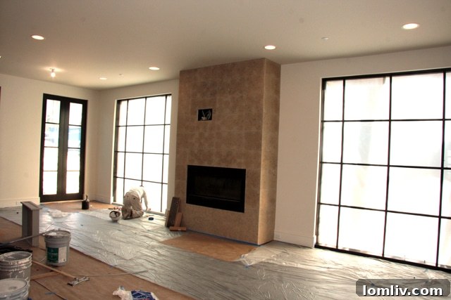 Living room with fireplace and steel windows in The Mondara Highland Park condos