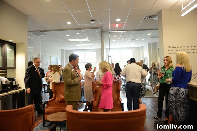 Briggs Freeman Debuts Plano Legacy Office Ahead of the Storm 3 Guests and team members mingling at the Briggs Freeman Sotheby's International Realty Plano office grand opening event
