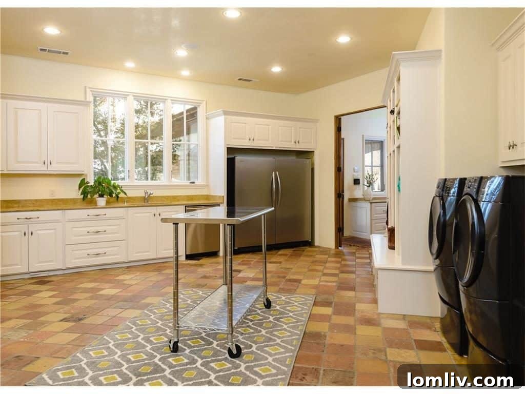 Spacious and well-appointed laundry room with ample storage and workspace