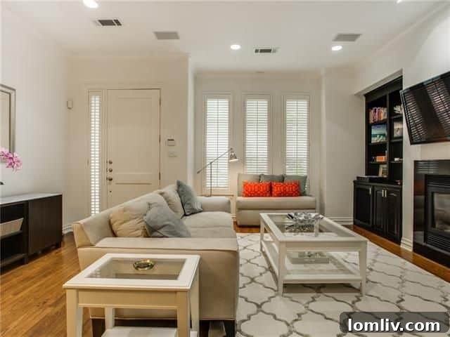 Elegant open-concept living room with fireplace and built-ins