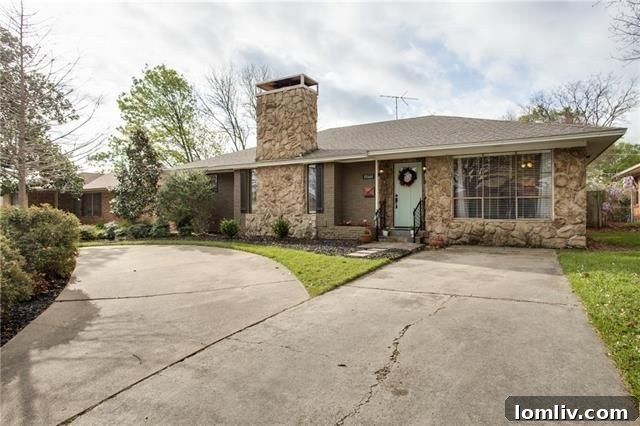 Well-maintained front yard and stone chimney of 10664 Lakemere Dr