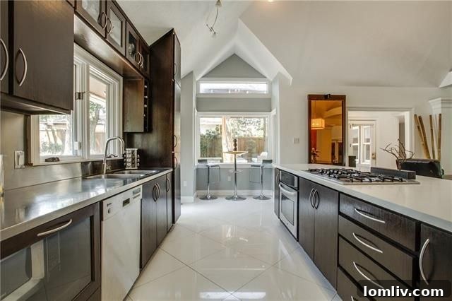 Modern kitchen with large island and stainless steel appliances in architect-designed home