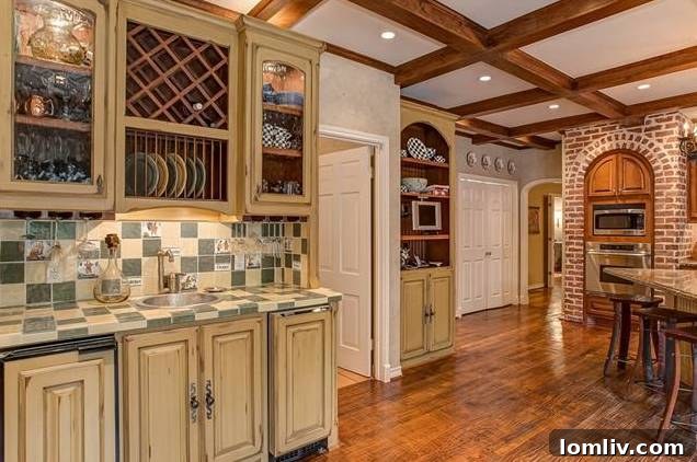Luxurious kitchen featuring a Dacor oven in a brick arch and breakfast nook