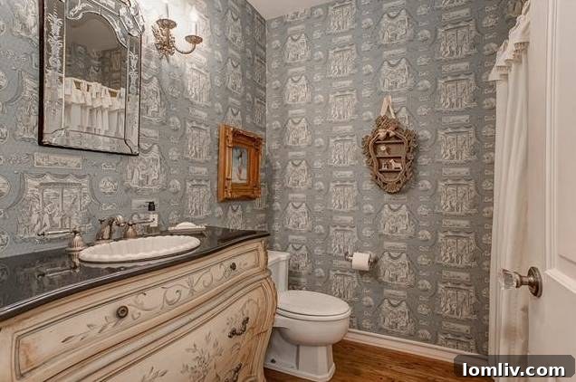 Opulent first-floor powder room with bombe form sink cabinet and deluxe hardware