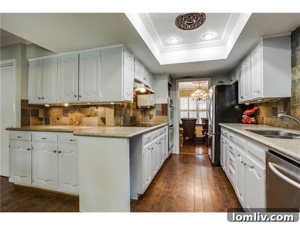 Modern kitchen at 4939 Harvest Hill, featuring stainless steel appliances and ample counter space.