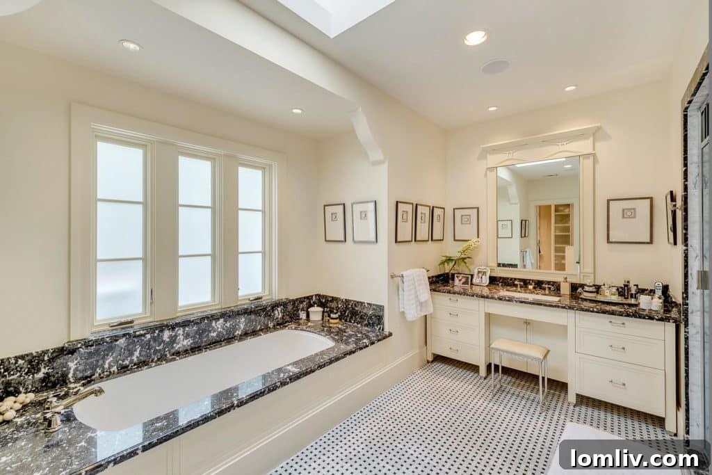 Luxurious master bathroom with opulent black marble and grand tub