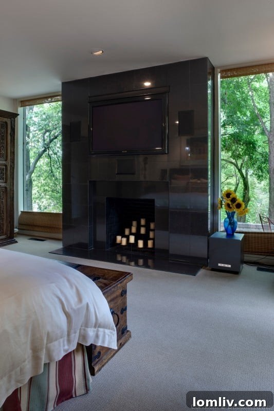 Elegant Master Bedroom with Fireplace and Panoramic Tree Views
