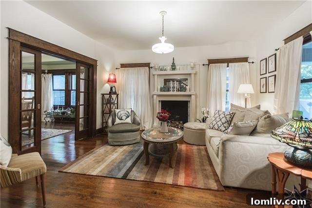 Spacious living room with original fireplace and hardwood floors