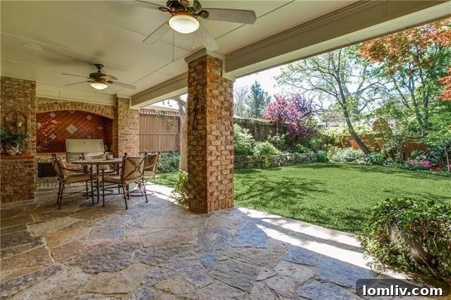 Covered outdoor living area with built-in grill