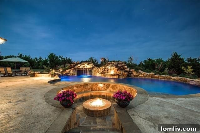 Outdoor kitchen with built-in grill and fireplace at McLendon Chisholm home
