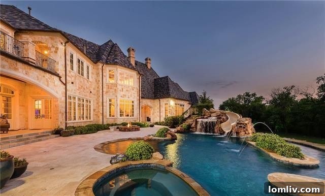 Plano French Traditional estate with grand exterior and lush landscaping