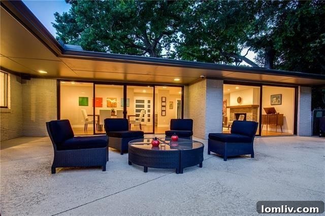 Swimming pool with water features and covered seating at MCM home