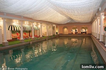 The Greenbrier's luxurious indoor pool, a tranquil space for relaxation and recovery, signifying the resort's return to its famed amenities.