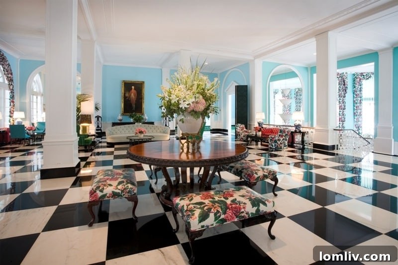 The opulent upper lobby of The Greenbrier, known for its exquisite decor, vibrant colors, and welcoming ambiance, symbolizing the resort's timeless elegance.