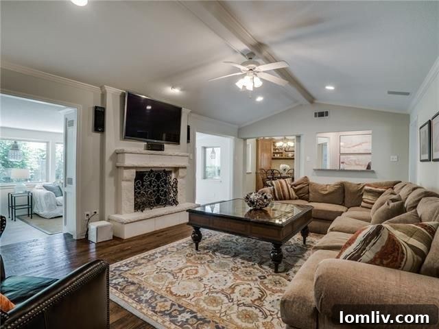 Spacious living room with vaulted ceiling and stone fireplace