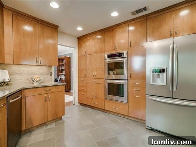 Modern kitchen with flat-front cabinets and stone accents