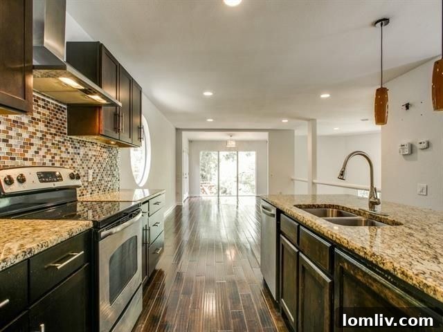 Modern kitchen with island, granite countertops, and glass tile backsplash