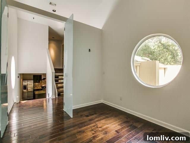Dedicated home office with unique circular window and etched glass doors