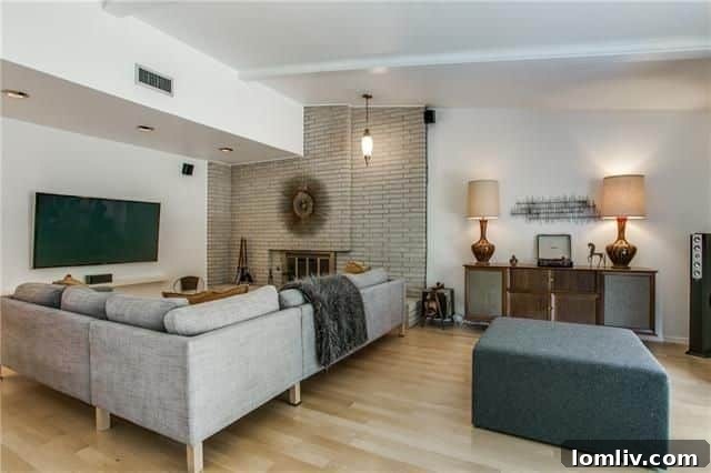 A closer look at the impressive floor-to-ceiling brick fireplace, a central feature of the living area