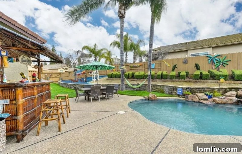 California's Parrothead Paradise: Your Margaritaville Escape 13 Expansive view of the backyard, highlighting the pool, patio, and the unique Parrothead themed elements in Folsom.
