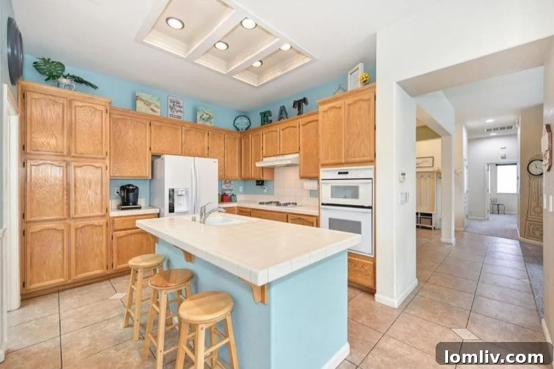 California's Parrothead Paradise: Your Margaritaville Escape 7 Bright and spacious open kitchen with a breakfast bar, light countertops, and views of the dining area in a Folsom home.