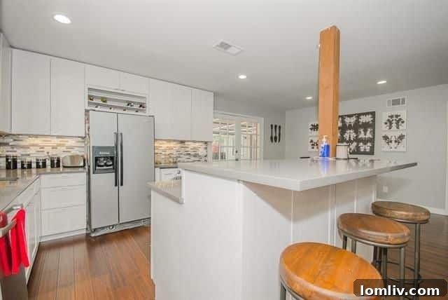 Gray quartz countertops and breakfast bar in Lochwood home