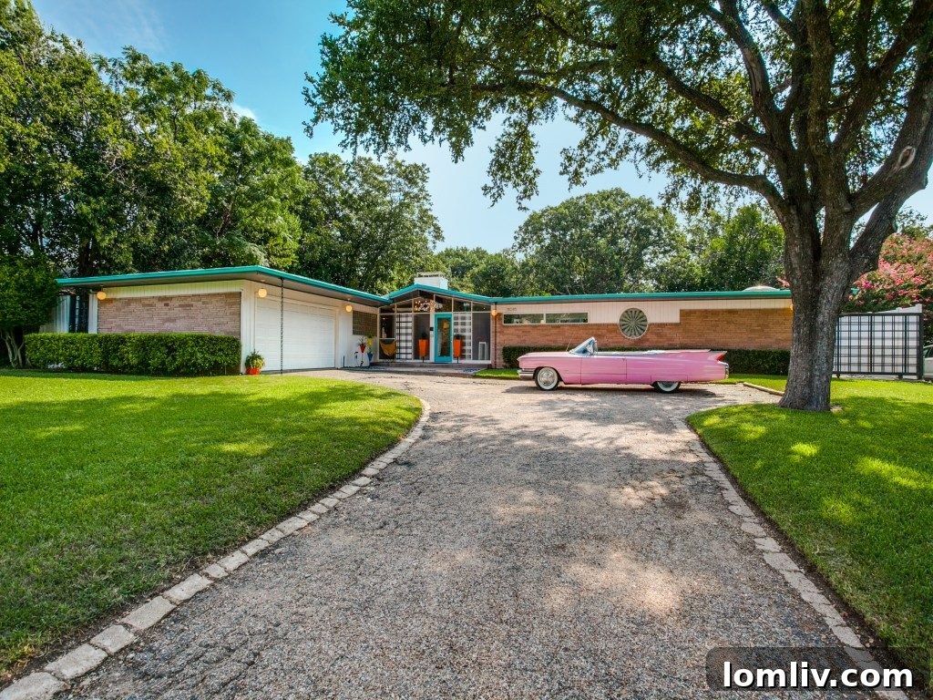 Exterior view of 11016 Pinocchio Dr, a striking pink Midcentury Modern home in Dallas TX