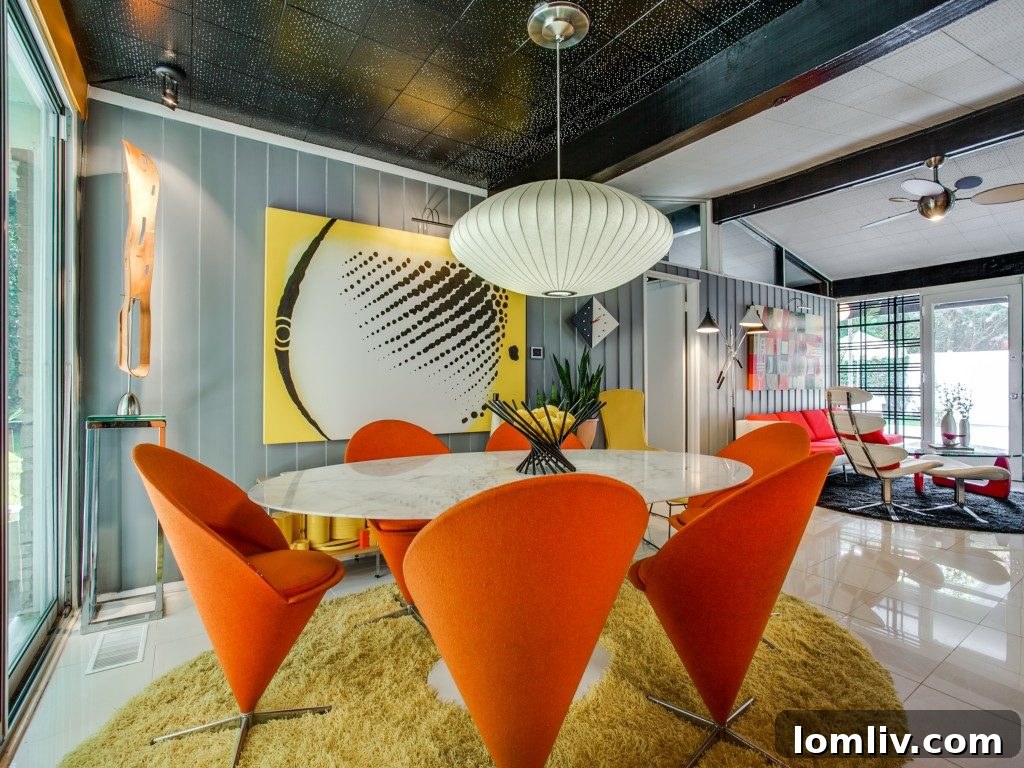 Charming vintage pink appliances and classic Formica countertops in the expertly restored Dallas MCM kitchen