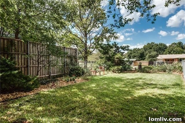 Exterior shot from a different angle, showing the private backyard